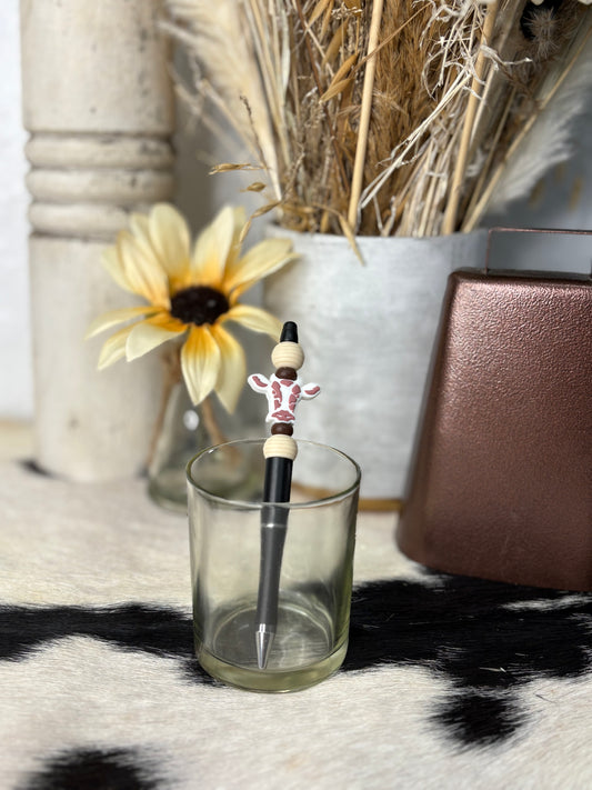 Brown cow with beige on black